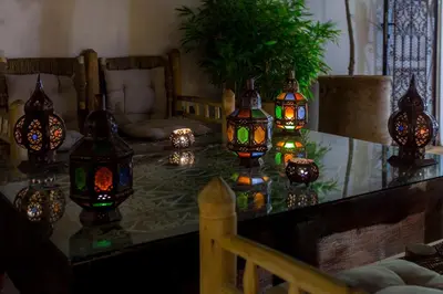 a group of lanterns on a glass table at Riad Chams Marrakech in Marrakech