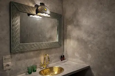 a bathroom with a gold sink and a mirror at Riad Lapis-lazuli in Marrakech