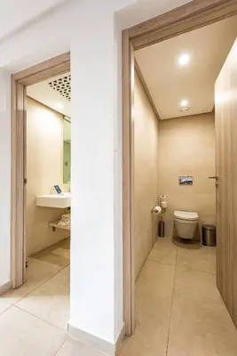a bathroom with a toilet and a sink at TUI BLUE Medina Gardens - Adults Only - All Inclusive in Marrakech