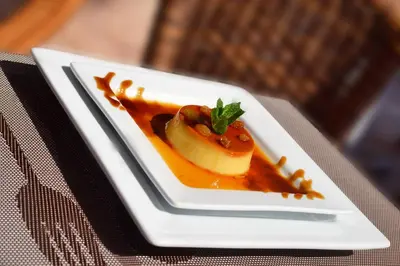a white plate with a dessert on a table at Appart Hotel Les Ambassadeurs in Marrakech