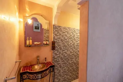 a bathroom with a sink and a mirror at Riad Haj Thami in Marrakech