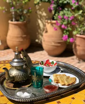 a tray with a tea pot and a plate of food at Riad Haj Thami in Marrakech