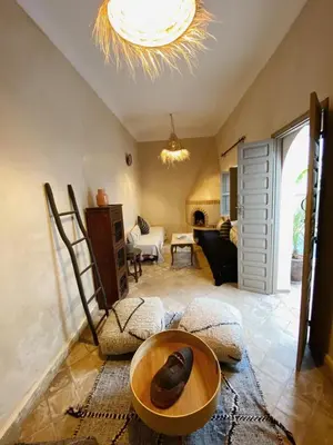 a living room with a table and a couch at Private house Riad Arlette exclusive in Marrakech