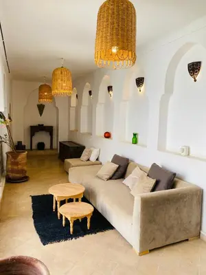 a living room with a couch and a table at Private house Riad Arlette exclusive in Marrakech
