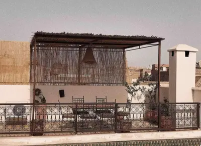 a pavilion with tables and chairs on top of a building at Private house Riad Arlette exclusive in Marrakech