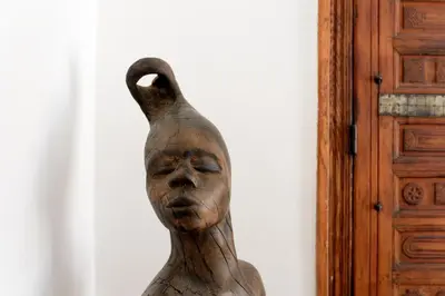 a wooden statuette of a woman with her head in at Riad Azzar in Marrakech