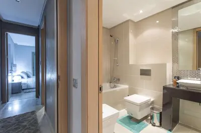 a bathroom with a toilet and a sink and a tub at Prestigia 16 in Marrakech