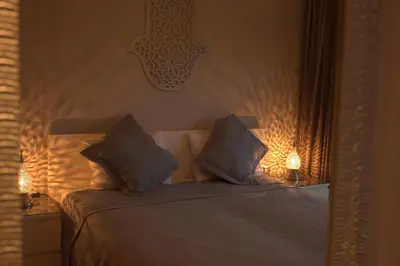 a bedroom with a bed with two pillows on it at Prestigia Golf City Apartment in Marrakech