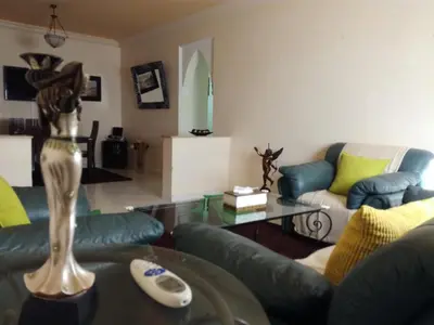 a living room with a couch and a table at Kim Apartment in Marrakech