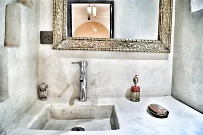 a bathroom with a sink and a mirror at Riad Abjaou in Marrakech