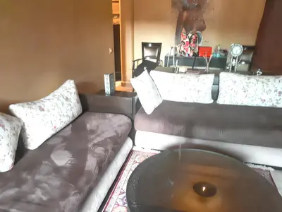 a living room with a couch and a coffee table at Comfortable Apartment in Marrakech with Shared Pool, 124 sqm in Marrakech