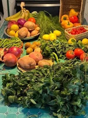 a table filled with lots of fresh fruits and vegetables at Riad Zeitoun Palace in Marrakech