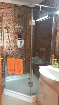 a bathroom with a shower and a sink and a glass shower stall at Mouzdalifa Apartment In City Center in Marrakech