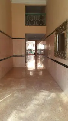 an empty hallway of a building with a mirror at Mouzdalifa Apartment In City Center in Marrakech