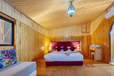 a bedroom with a bed and a wooden wall at Ferme Sidi Safou & Spa in Marrakech