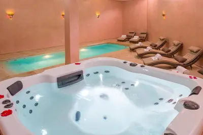 a bath tub in a room with a swimming pool at La Palmeraie De L'Atlas in Marrakech