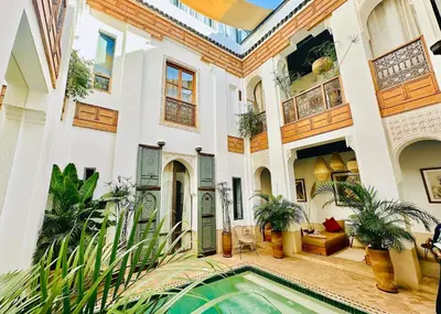 a house with a swimming pool in front of it at Riad Jardin Des Sens & Spa in Marrakech