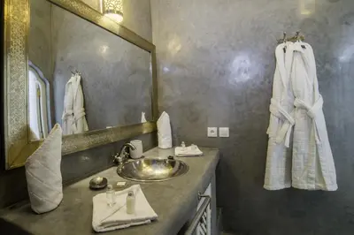 a bathroom with a sink and a mirror at Riad Palais Blanc & Spa in Marrakech