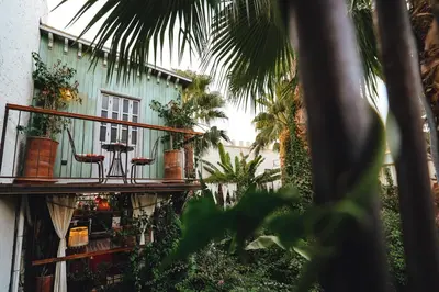 a building with a balcony with plants on it at La Ferme Medina in Marrakech