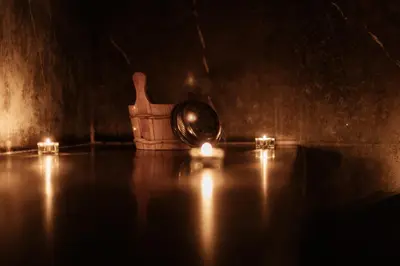 a dark room with two candles and a table at Wazo Appart-Hôtel in Marrakech