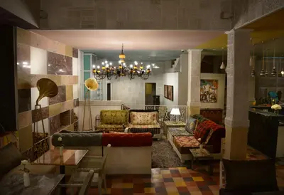 a living room with couches and a chandelier at Riad Karmela Princesse in Marrakech