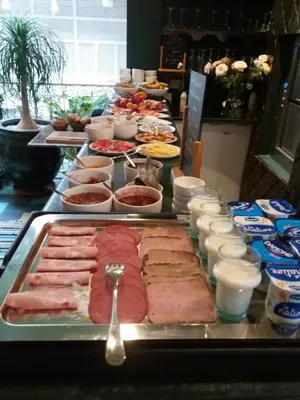 a buffet of food with meat and other foods at Riad Karmela Princesse in Marrakech