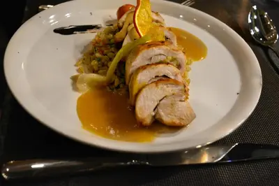 a plate of food with meat and rice on a table at Riad Karmela Princesse in Marrakech