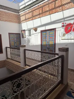 a staircase with a railing with stained glass doors at Riad Dihya in Marrakech