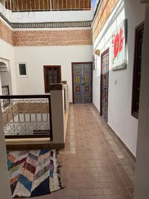 a hallway with two doors and a tile floor at Riad Dihya in Marrakech