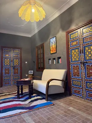 a living room with a couch and a table at Riad Dihya in Marrakech