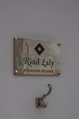 a sign that reads raid ladyulic exchange on a wall at Riad Laly Tourisme Eclairé Le bijou de la medina in Marrakech