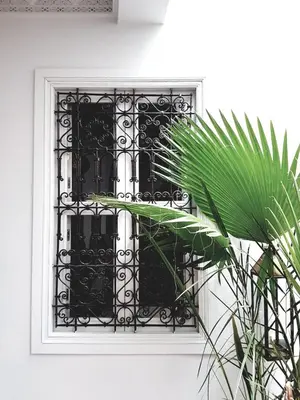 a window with a black wrought iron grate at Riad Laly Tourisme Eclairé Le bijou de la medina in Marrakech
