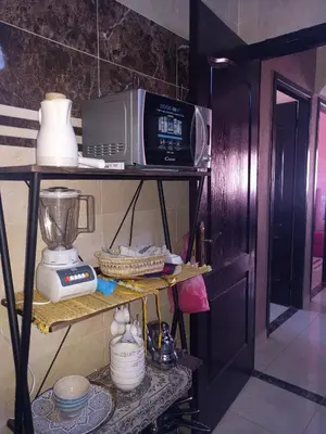 a kitchen shelf with a microwave and a blender at Appartement Marrakech in Marrakech