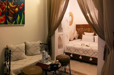 a small room with a bed and a couch at Riad Alili in Marrakech