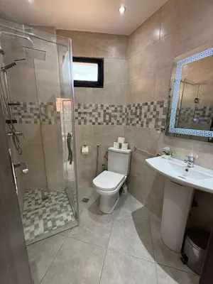 a bathroom with a toilet and a shower and a sink at Appartement Nour Guéliz Marrakech in Marrakech