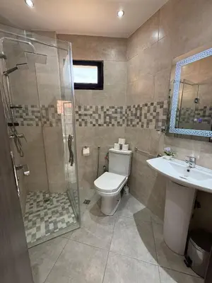 a bathroom with a toilet and a shower and a sink at Appartement Nour Guéliz Marrakech in Marrakech