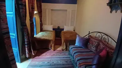 a living room with a couch and a table at Riad Tiziri in Marrakech