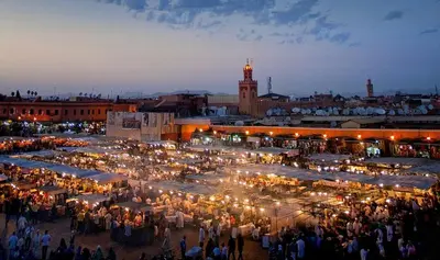 a crowd of people standing around a market at night at Appartement Wassim - Gueliz in Marrakech