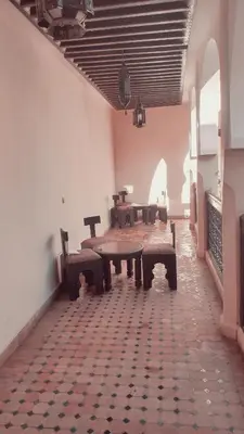 a room with tables and benches in a building at Riad Tidar by Phoenix in Marrakech