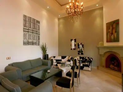a living room with a couch and a fireplace at Maison d'hote Oceania in Marrakech