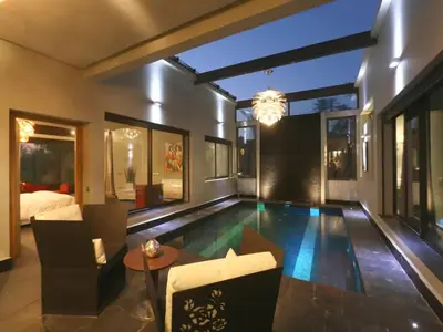 a living room with a swimming pool and a bedroom at Maison d'hote Oceania in Marrakech