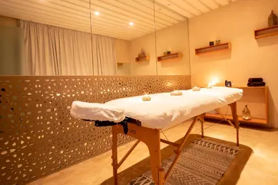 a bathroom with a table and a mirror at Villa Jardins D'Isa in Marrakech