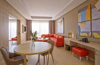 a living room with a table and a couch at Be Live Collection Marrakech Adults Only All inclusive in Marrakech