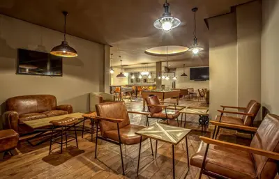 a bar with chairs and tables in a room at Be Live Collection Marrakech Adults Only All inclusive in Marrakech