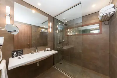 a bathroom with a sink and a shower at Be Live Experience Marrakech Palmeraie - All Inclusive in Marrakech