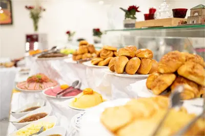 a buffet line with plates of pastries and other foods at Palm Menara Hotel Marrakech in Marrakech