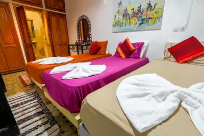 two beds sitting next to each other in a room at Riad Salma Restaurant Spa in Marrakech