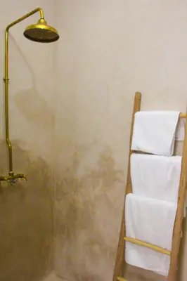 a shower with a towel rack and a lamp at Riad Al Tainam in Marrakech