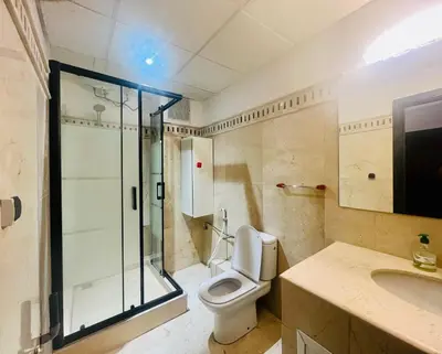 a bathroom with a toilet and a shower and a sink at Sabor Apartments Anas Majorelle in Marrakech