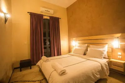 a bedroom with a large bed with white sheets and pillows at Les Résidences Du Domaine in Marrakech